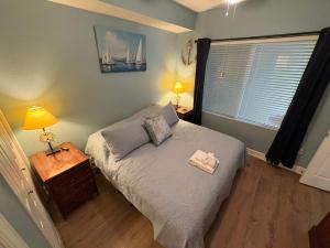 a bedroom with a bed and a table with a lamp at Oceanfront Condo with Shared Pool Hot Tub & Gym in Panama City Beach
