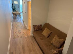 a living room with a couch and a dining room at Oceanfront Condo with Shared Pool Hot Tub & Gym in Panama City Beach +3 photos