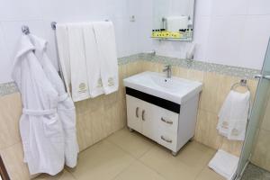 a bathroom with a sink and white towels at Cathedral Plaza Hotel in Gyumri +54 photos