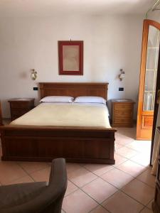 a bedroom with a bed and a chair at Villa Mattera - Sea - Hot Springs - Private Parking in Barano d'Ischia