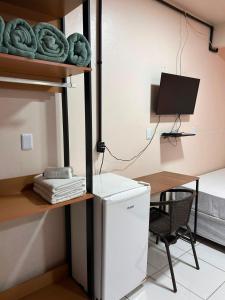 a room with a desk and a computer and a bed at Pousada Rota do Parque in Penha +63 photos