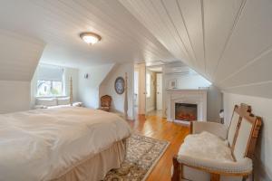 a bedroom with a large bed and a fireplace at The Cottage and Castle in Chemainus