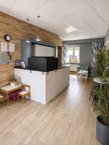 an office with a reception counter and tables and chairs at Hostel Filip 2 in Gdańsk