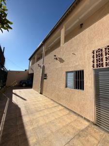 a side view of a brick building with a driveway at Pousada Flor do Vale in São José dos Campos
