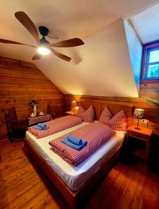 a bedroom with a bed with a ceiling fan at Sonnleiten Zimmer 4 in Abtenau