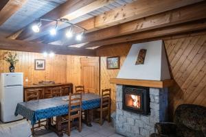 a kitchen with a table and a fireplace in a room at la bergerie in Mialanes