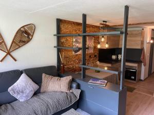 a living room with a couch and a table at Panorama à La Mongie in La Mongie +4 photos