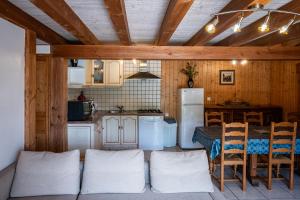 a kitchen with a couch and a table in a room at la bergerie in Mialanes +14 photos