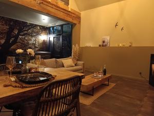 a living room with a couch and a table at Terra Serena in Frasnes-lez-Anvaing +2 photos