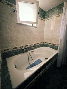 a white bath tub in a bathroom with a window at Casa Marrone in Proskinitaí +12 photos