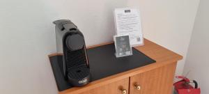 a hair dryer sitting on top of a wooden dresser at 5 Suites Αγιόκαμπος Αγιάς in Agiokampos