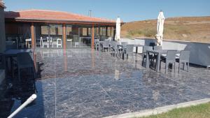 a group of tables and chairs on a patio at Akarca Elite Pansiyon in Seferihisar