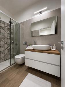 a bathroom with a sink and a toilet and a shower at Casa Tanca Marchese in Marrùbiu +11 photos