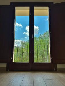 an empty room with two large glass doors with a view at Casa Tanca Marchese in Marrùbiu