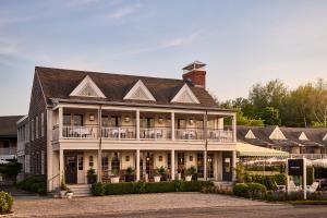 a large white building with a porch at Faraway Sag Harbor in Sag Harbor