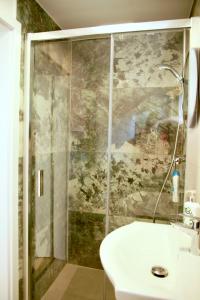 a bathroom with a shower and a white sink at Officium P47 in Rakamaz