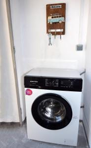 a washer and dryer with a car on the wall at Olympian Kavala in Kavála