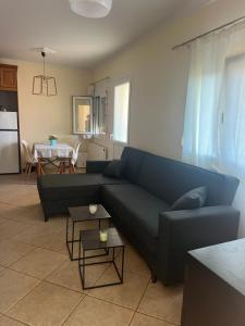 a living room with a blue couch and a table at Renas' Apartments in Chios island in Chios