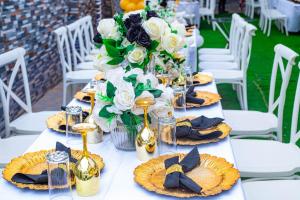 a table with plates of food and flowers on it at EdJames Lodge in Ashaiman +19 photos