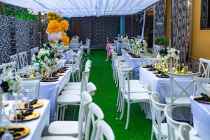 a wedding reception with white tables and white chairs at EdJames Lodge in Ashaiman