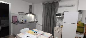 a small kitchen with a table and a refrigerator at MariaS Vacation Rental in Obregón +17 photos