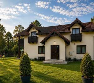 a large white house with a grass yard at Garden Retreat Keyhouse in Bran