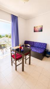 a living room with a table and a couch at Louis' apartment with view in Gythio