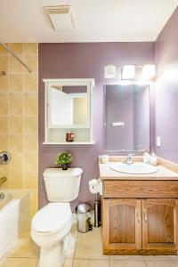 a bathroom with a toilet and a sink and a mirror at Nimo Homestay in Guelph +7 photos