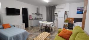 a living room with a couch and a kitchen at MariaS Vacation Rental in Obregón