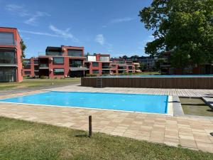 an empty swimming pool in front of a building at Balino 57 in Balatonlelle +8 photos