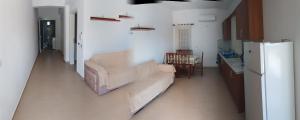 a living room with a couch and a refrigerator at Vila Bali in Durrës +39 photos
