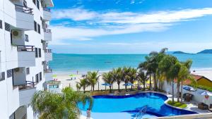 a view of the beach from the balcony of a hotel at Hotel Palace 1 in Florianópolis