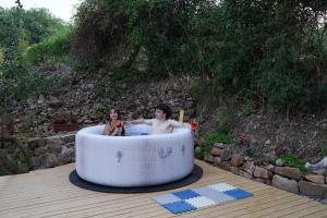 a couple of people sitting in a bath tub at glamping giardino museo a gisa in Petralia Sottana +27 photos