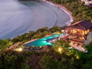 an aerial view of a resort with a pool and a beach at Casa Chameleon Hotel Las Catalinas - Adults Only in Playa Flamingo +75 photos