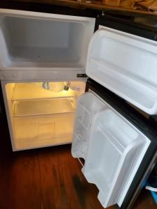 an open refrigerator with its door open at Private Beachfront Beach Hut in Manzanillo