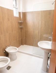 a bathroom with a toilet and a sink and a shower at Departamento in Formosa