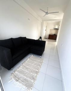 a living room with a black couch and a rug at Departamento in Formosa