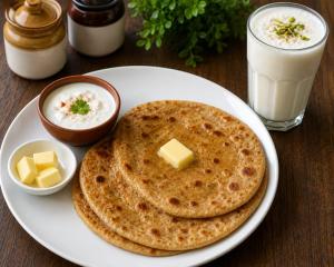 a plate of pancakes with cheese and milk on a table at Hotel The Montana Suite - Free Airport and Aerocity Pickup & Drop in New Delhi