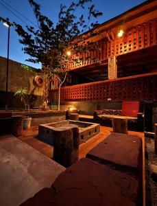 a patio with tables and benches in front of a building at Balletto Boutique in Arusha