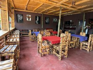 a restaurant with wooden tables and chairs in a room at Balletto Boutique in Arusha