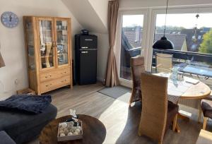 a living room with a couch and a table at Ferienwohnung Möwenschiss - Haus Bake in Büsum