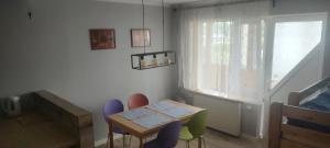 a room with a table and chairs and a window at Willa Madi in Grzybowo