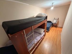 a room with two bunk beds in it at Deptos Valen in Trevelín