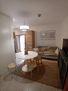 a living room with a table and chairs and a bedroom at U muntagna Olmo in Olmo