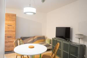 a living room with a table and a couch at U muntagna Olmo in Olmo