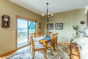 a dining room with a table and chairs and a large window at Breathtaking Mtn & Lake Views! Glacier Country Gem in Dayton