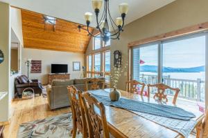 a dining room and living room with a table and chairs at Breathtaking Mtn & Lake Views! Glacier Country Gem in Dayton