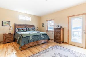 a bedroom with a bed and a window at Breathtaking Mtn & Lake Views! Glacier Country Gem in Dayton