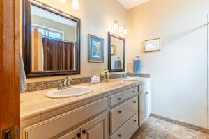 a bathroom with two sinks and a mirror at Breathtaking Mtn & Lake Views! Glacier Country Gem in Dayton +31 photos