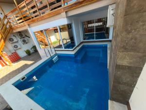 a swimming pool in the middle of a house at Casa playera in Crucita
